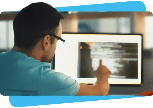 man pointing to information on screen - software vendor payment solutions